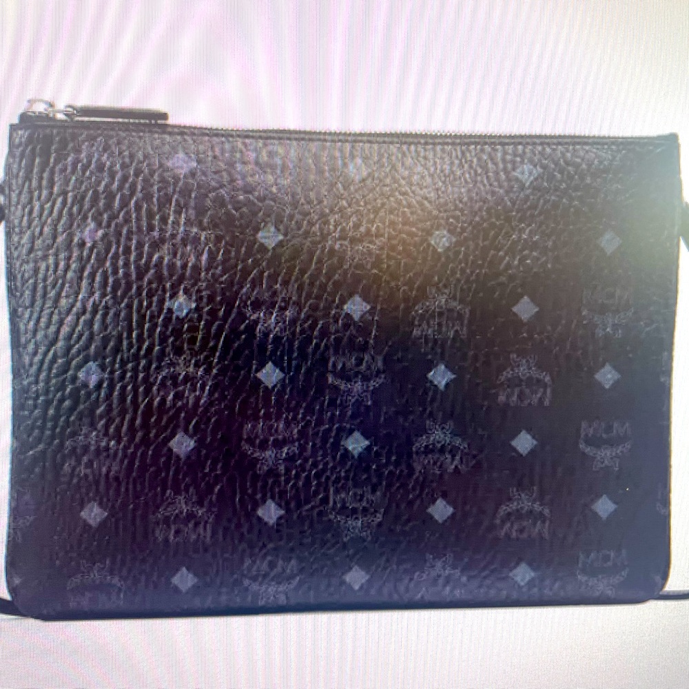 MCM Signature Crossbody pouch Top zipper closure.Interior zip pocket 8.3 x 11.6
